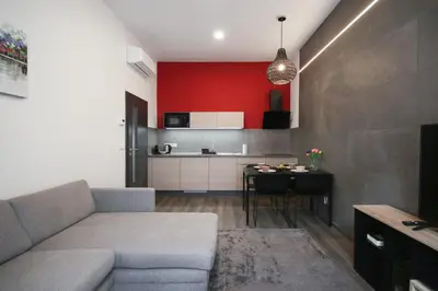 a living room with a couch and a table at CORU House in Prague