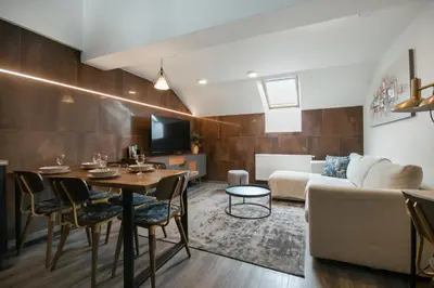 a living room with a couch and a table at CORU House in Prague