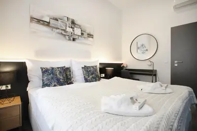 a bedroom with a bed with two towels on it at CORU House in Prague