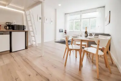 a kitchen and dining room with a table and chairs at Studio Mala Strana - Prague historical center in Prague