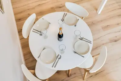 a white table with glasses and a bottle of wine at Studio Mala Strana - Prague historical center in Prague