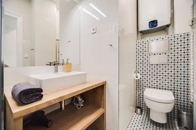 a bathroom with a white sink and a toilet at Studio Mala Strana - Prague historical center in Prague