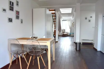 a dining room with a table and chairs at Lux Duplex rooftop loft with an amazing terrace & home cinema in Prague