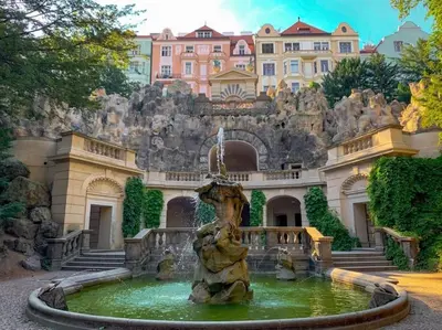 a fountain in front of a building with a castle at Lux Duplex rooftop loft with an amazing terrace & home cinema in Prague