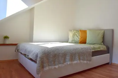 a bed in a room with a window at NEW CENTRAL ROOFTOP with private WELLNESS, Sauna & Whirlpool bath in Prague