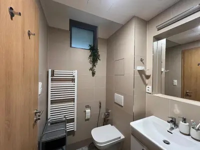 a bathroom with a toilet and a sink at Kora Apartments in Prague