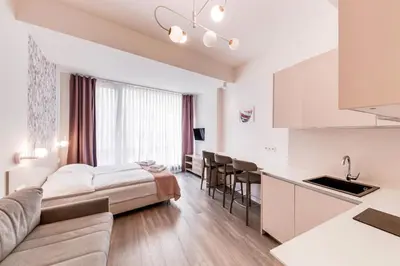 a hotel room with a bed and a kitchen at Kora Apartments in Prague