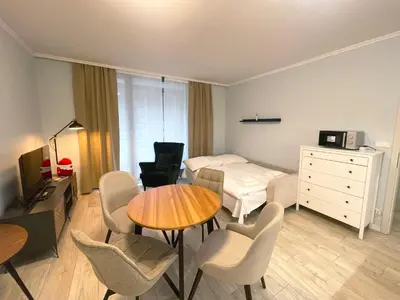 a hotel room with a bed and a table and chairs at Kora Apartments in Prague
