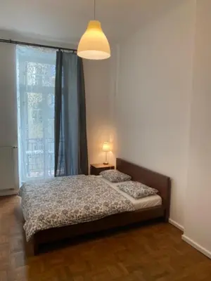 a bedroom with a bed and a large window at 3 Bed Flat - Sleeps 10 - Pets - Smoking on terrace in Prague