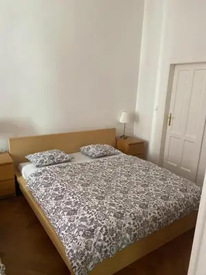 a bed with two pillows on it in a bedroom at 3 Bed Flat - Sleeps 10 - Pets - Smoking on terrace in Prague