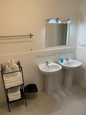 a bathroom with two sinks and a mirror at 3 Bed Flat - Sleeps 10 - Pets - Smoking on terrace in Prague