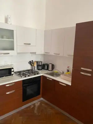 a kitchen with white cabinets and a stove top oven at 3 Bed Flat - Sleeps 10 - Pets - Smoking on terrace in Prague