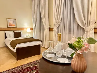 a hotel room with a bed and a table with a tray of food at FLEUR DE LIS HOTEL in Prague
