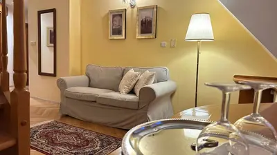 a living room with a couch and a table at FLEUR DE LIS HOTEL in Prague