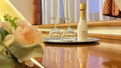 a bottle of wine and two glasses on a table at FLEUR DE LIS HOTEL in Prague