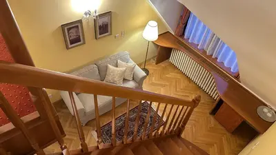 a living room with a couch and a staircase at FLEUR DE LIS HOTEL in Prague