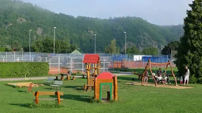 a playground with a bunch of playground equipment in a field at Hotel VZ Měřín in Merin