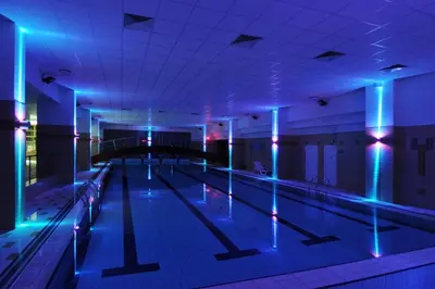 an empty swimming pool with blue and purple lights at Hotel VZ Měřín in Merin