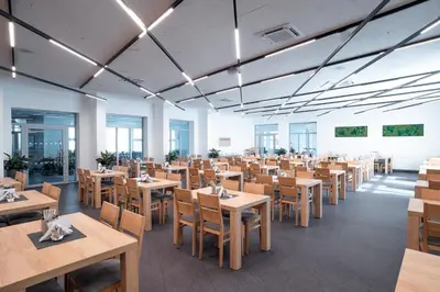 a dining room with wooden tables and chairs at Hotel VZ Měřín in Merin