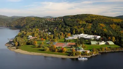 a large house on an island in the water at Hotel VZ Měřín in Merin