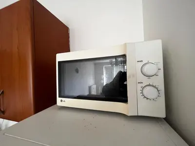 a microwave oven sitting on top of a counter at MONFas APARTMENT GARDEN CITY in Prague