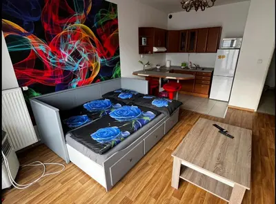 a small room with a bed in a kitchen at MONFas APARTMENT GARDEN CITY in Prague