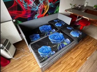 a bed with blue roses in a room at MONFas APARTMENT GARDEN CITY in Prague