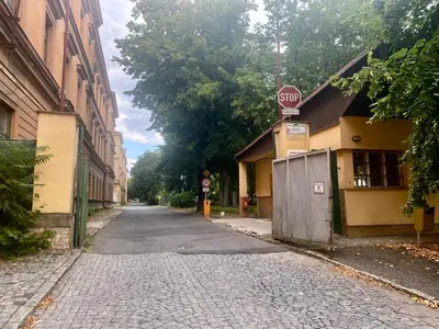 an empty street with a stop sign on a pole at Penzion Zahrada Čech in Litoměřice