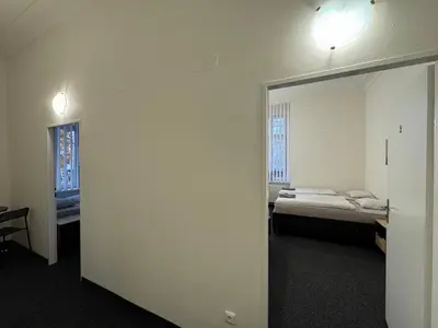 a room with two beds and a mirror at Penzion Zahrada Čech in Litoměřice
