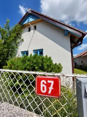 a sign on a fence in front of a house at Modré okno in Kozojedy