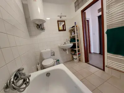 a bathroom with a tub and a toilet and a sink at Modré okno in Kozojedy