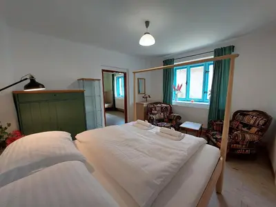 a bedroom with a large white bed in it at Modré okno in Kozojedy