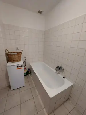 a bath tub in a bathroom with a basket on top of it at Modré okno in Kozojedy