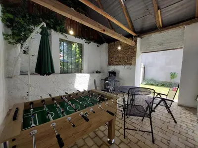 a room with a foosball table and a table and chairs at Modré okno in Kozojedy