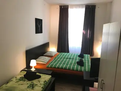 a bedroom with two twin beds and a window at 3 Bed Flat - Sleeps 20 - Smoking room - Wifi in Prague