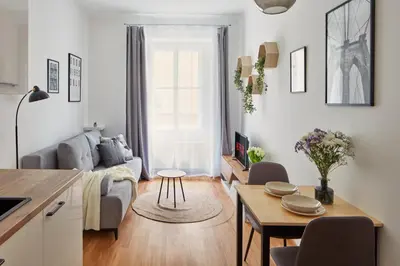 a living room with a couch and a table at Prague Days - Modern Apartments w Easy City Access in Prague