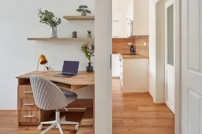 a home office with a desk and a laptop at Prague Days - Modern Apartments w Easy City Access in Prague