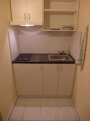 a small kitchen with a sink and a counter at Hotel Harfa in Prague