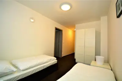 a room with two beds and a hallway at Hotel Harfa in Prague