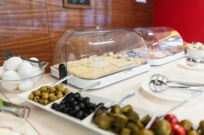 a buffet with eggs and fruit on a table at Hotel Ehrlich Prague in Prague