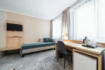 a hotel room with a bed and a desk at Hotel Ehrlich Prague in Prague