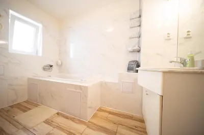 a white bathroom with a sink and a mirror at Celý dům s vybavenou kuchyní, koupelna s vířivkou in Prague