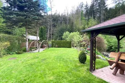a garden with a playground and a gazebo at Charming cottage KLARA with Sauna, Nature&Privacy near Prague in Malé Kyšice
