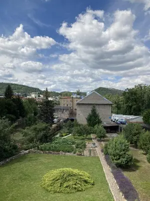 a view of a garden with a building in the background at Apartmán Na Ostrově Beroun in Beroun