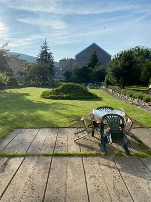 a statue of a bird sitting on a wooden table at Apartmán Na Ostrově Beroun in Beroun