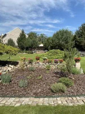 a garden with flowers and plants in a yard at Apartmán Na Ostrově Beroun in Beroun