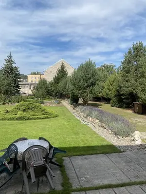 a park with two park benches and a lawn at Apartmán Na Ostrově Beroun in Beroun
