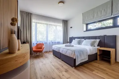 a house with a courtyard with chairs and trees at Vista Resort & Club in Prague