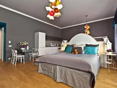 a bedroom with a large bed with blue pillows at Royal Prague City Apartments in Prague