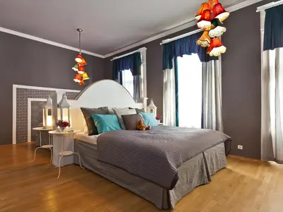 a bedroom with a large bed with blue walls at Royal Prague City Apartments in Prague